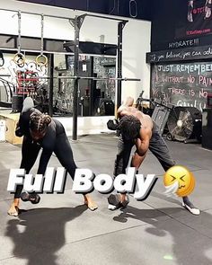 two people doing push ups in front of a building with graffiti on the wall behind them