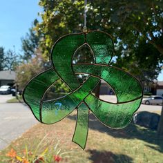 a stained glass wind chime hanging from a tree