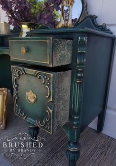 an ornate green desk with mirror on top