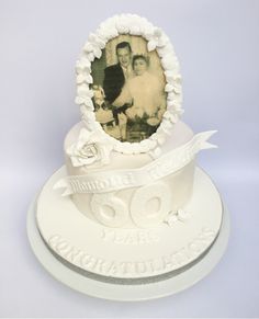 a white cake with an old photo on top