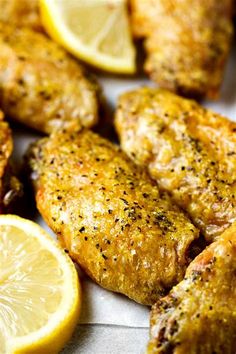 chicken wings with lemons and spices on the side