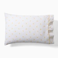 a white pillow with yellow polka dots on it