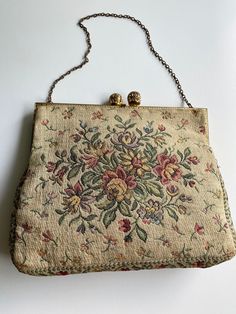 "Vintage 1960s Shoulder Bag Tapestry Chain Purse. Gold frame with decorative Kiss Clasp Closure. Multi Floral Tapestry Motif on Ivory Background. Peach Sateen Lining. Gold tone 5\" chain This is an absolute must for the Tapestry Handbag Collector.-- Very Good Condition  Measurement: 5.5\" x6.5\" x 1\" 5.5 Chain drop" Vintage Embroidered Tapestry Shoulder Bag, Vintage Beige Embroidered Shoulder Bag, Vintage Evening Bag In Tapestry Material, Vintage Tapestry Bag For Evening, Vintage Tapestry Bag For Formal Occasions, Vintage Formal Tapestry Bag, Vintage Beige Tapestry Bag, Formal Vintage Tapestry Bag, Vintage Tapestry Shoulder Bag For Evening