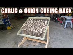 garlic and onion curing rack in a garage with the words garlic & onioncuring rack