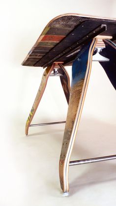 an upside down skateboard sitting on top of a metal stand