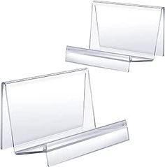 two clear acrylic business cards holders on a white background with clippings