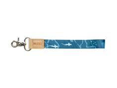 a keychain with an image of sharks on the front and blue, camouflage - print