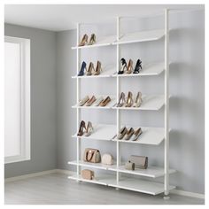 a white shelving unit filled with lots of shoes