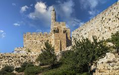 an old stone castle on top of a hill