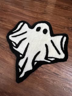 a black and white rug with a ghost on it