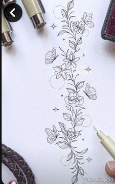 someone is drawing flowers on the paper with their pen and inking it in pencil