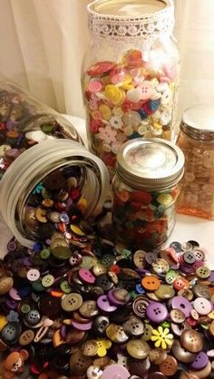 a jar filled with lots of different colored buttons