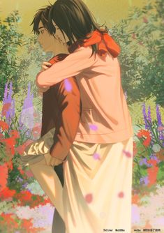 a man and woman standing next to each other in front of flowers