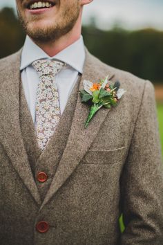 a man wearing a suit and flower boutonniere