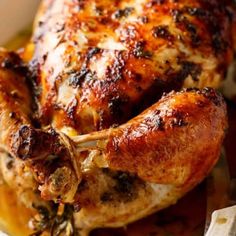 a cooked chicken sitting on top of a wooden cutting board