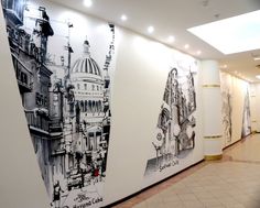 the wall is decorated with black and white drawings on it's sides, along with an elevator