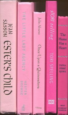 the pink books are lined up on the shelf