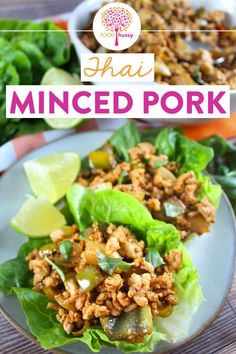 lettuce wraps filled with minced pork and garnished with limes