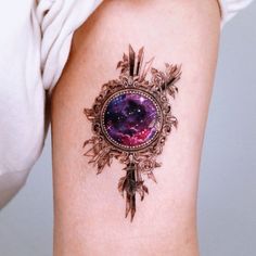 a woman's arm with a tattoo on it that has an image of the earth and stars