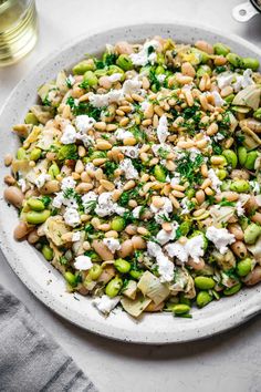 a white plate topped with lots of veggies and cheese