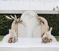 an outdoor ceremony setup with flowers and feathers