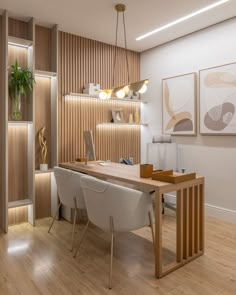 a home office with wood paneling and white chairs in front of a wooden desk