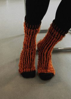 Information These are your statement socks. Inspired by the Lorax, the Fuzzy socks feature a reverse knit which make for a pop! Pair them with your favorite boots or sneakers. Material 81% Cotton, 15% Polyester2% Nylon, 2% Polyurethane Trendy Knitted One Size Socks, Trendy Knitted One-size Socks, Cozy Black Knitted Socks, Black Knitted Socks For Stocking Stuffer, Casual Knit Winter Socks, Casual Orange Socks For Winter, Casual Orange Winter Socks, Casual Chunky Knit Socks For Fall, Winter Streetwear Socks