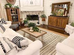 a living room filled with furniture and a fire place in the centerpiece on top of a rug