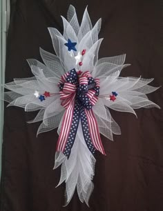 an american flag bow with stars and stripes on the front, attached to a brown background