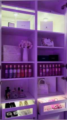 the shelves are filled with cosmetics and other items in purple lighting, including perfume bottles