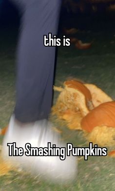 a person with their foot on the ground next to a pumpkin that has been smashed