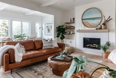 a living room filled with furniture and a fire place in the middle of a room