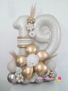 an image of balloons in the shape of numbers with flowers and pearls on them for a 50th birthday party