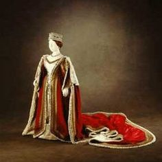 a red and white dress with a crown on it is sitting next to a bag