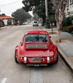 a red car parked on the side of a street