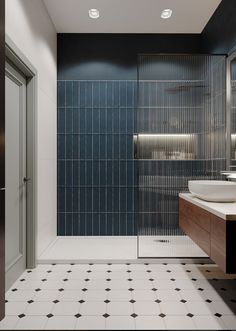 a bathroom with black and white tiles on the walls, flooring and shower stall