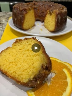 a piece of cake sitting on top of a white plate next to an orange slice