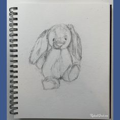 a drawing of a bunny sitting on top of a white paper