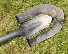 two knives are laying on the ground with grass growing out of it's blades