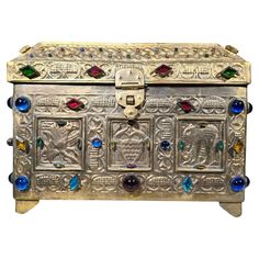 an ornately decorated chest with many colorful glass beads on the front and side panels