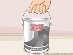 a paint can with the words wonder painted on it and someone's hand pointing at it