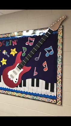 a guitar and musical instruments are hanging on the wall