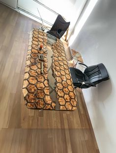 a table made out of honeycombs in the middle of a room with chairs