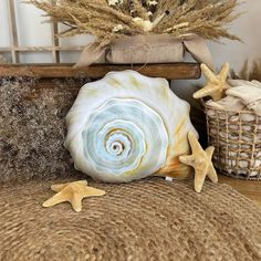 starfish and seashells are on the floor next to a basket