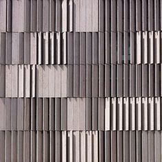 the side of a building that has many vertical lines on it