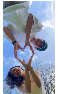 two people making a heart shape with their hands