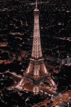 the eiffel tower lit up at night in paris, france with its lights on