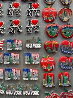 the new york city souvenirs are on display in front of other magnets