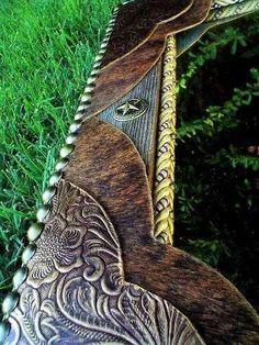 an intricately decorated wooden horse laying in the grass