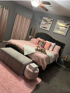 a bed room with a neatly made bed and pink rugs